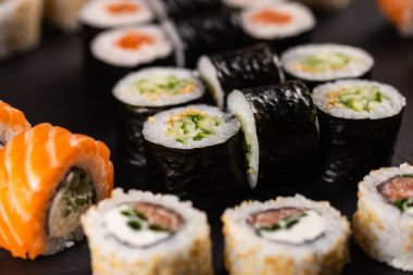 Rolls set with fish and shrimp caviar sushi with chopsticks - asian food and japanese cuisine concept