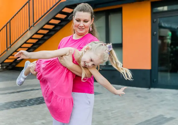 stock image Deaf child with cochlear implant for hearing audio and aid for impairment having fun and laughs with mother outdoor in summer. Sound fitting device to help with communication listening and interaction