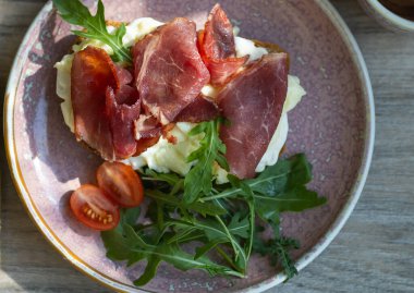 Breakfast sandwich. Scrambled eggs and jamon on whole grain bread. High quality photo