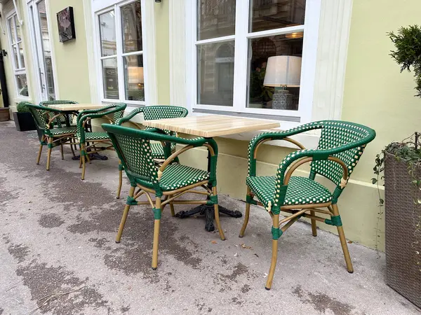 Boş kafeterya masaları ve sandalyeler sessiz bir şehir ortamında. Günlük yaşamda şehir rutini, boş zaman ve açık alan.