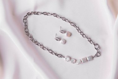 Handmade jewelry on a textile background. Gift for women. Bijouterie and jewellery for women