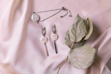 Handmade jewelry on a textile background. Gift for women. Bijouterie and jewellery for women