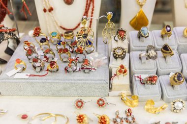 Renkli taşlı, el yapımı yüzük ve küpe koleksiyonu. Zanaatkâr mücevherler, zarif aksesuarlar ve lüks piyasa tarzı..