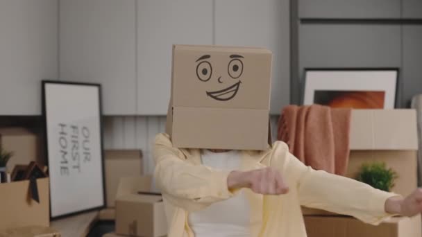 Woman Dances Cardboard Box Head Celebrating Buying New Home Female — Stock Video