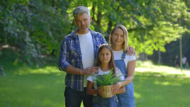 Portrait Happy Caucasian Family Standing Park Girl Holding Pot Plant — Stock video