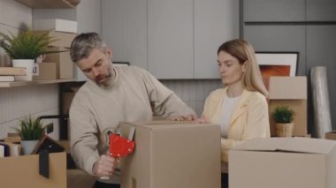 Family Is Packing Carton Boxes with Home Things for Relocation. Real Estate, Carrying Boxes. New Home, Moving, Housing Service Concept
