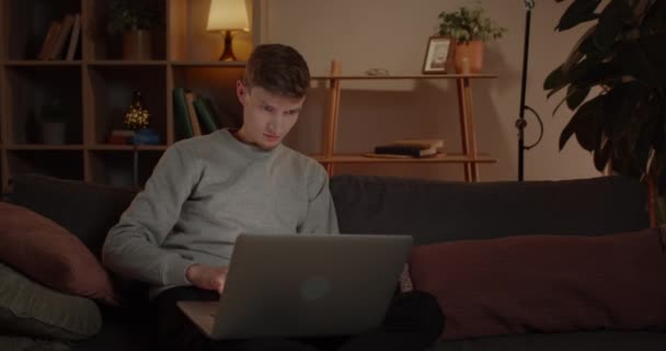 Handsome Young Man Using Laptop While Sitting Sofa Home Male — Vídeo de stock