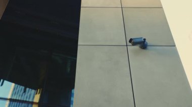 Watchful Eye: CCTV Security Camera Captures Daytime Activity in the Business Center of the Modern District. Safety and Building Concept. Outside