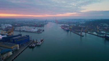 Gdynia Limanı 'nın üzerinde uçan bir hava manzarası. Lojistik, Ulaşım ve Sevkiyat Yukarıdan Çekildi. Devasa vinçleri ve gemileri olan devasa bir liman.