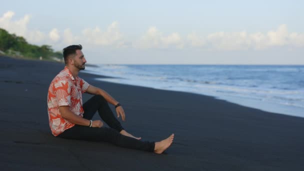 Multiethnic Handsome Guy Sitting Black Sand Beach Dreaming While Watching — Stock Video