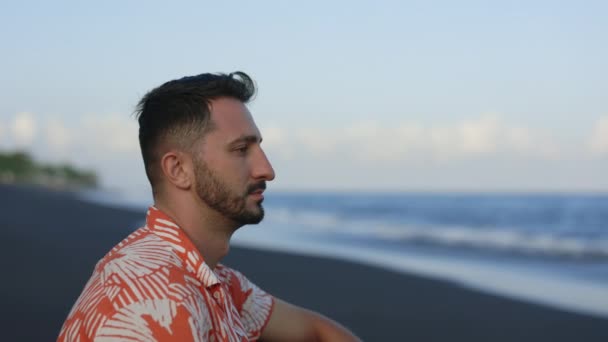 Serious Multiethnic Young Guy Sitting Ocean Background Thinking Watching Ocean — Stock Video