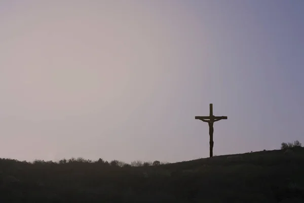 Cross silhouette with purple sky in the background.