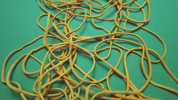 Yellow Office Rubber Bands Green Surface Close Shot High Quality — Vídeo de stock