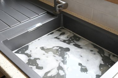 Tıkanmış lavabo, tıkanmış lavabo, su tesisatı sorunları, açılmaya çalışılıyor.