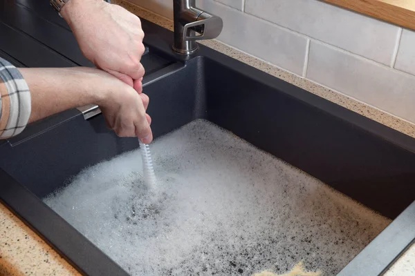 stock image Overflowing kitchen sink, clogged drain, plumbing problems, trying to unclog