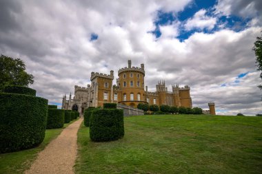 Grantham, Leicestershire, England- 22 August 2023: Outside view of castle, Belvoir Castle is a faux historic castle and stately home in Leicestershire, England, A castle was first built on the site immediately after the Norman Conquest of 1066 clipart