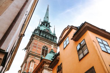 Stockholm, Sweden. Extreme low angle view of Gamla Stan buildings with Saint Gertrud steeple