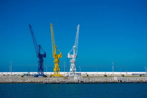 stock image Tangier, Morocco. January 22, 2024. Three old port cranes painted in different colours 