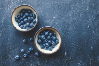 Koyu arkaplan manzaralı tabakta taze yaban mersini..