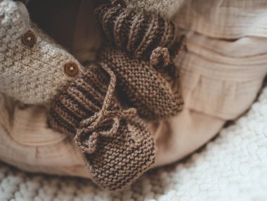 Beşikteki yeni doğmuş bir bebek için terlik örüyorsun..