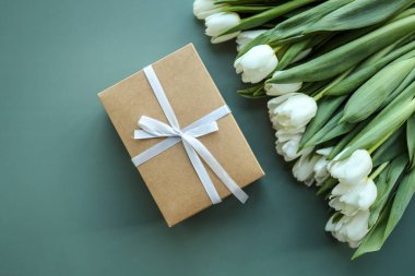 Pink tulips flowers and gift or present box pink background. Mothers Day, Birthday, Valentines Day, Womens Day, celebration concept. Space for text.