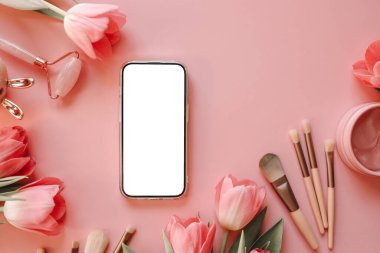 Kozmetik ürünlerinin arka planında izole ekran olan telefon.
