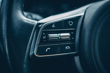 Hızlı kontrol için çok fonksiyonlu modern siyah direksiyon, arabada yakın çekim.