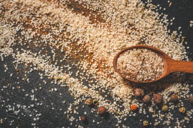 Siyah arka planda farklı baharatlı ahşap kaşıklar, afiş..