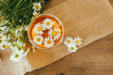 Glass cup of chamomile tea on the table