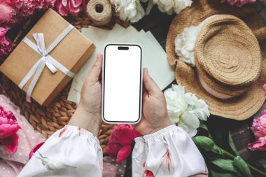 Neşeli bir arka planda cep telefonu ve bahar çiçekli şakayıklar. Aşk teması, Anneler Günü, Kadınlar Günü düzlük.