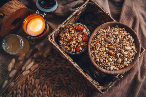 Homemade granola in a wooden bowl top view.