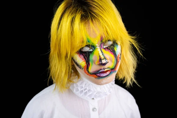 stock image Portrait of woman with yellow hair and evil clown face art posing on black background
