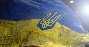 Ukrayna rüzgarda dalgalanan hasarlı bayrak kullandı. Direnişin ve zaferin sembolü, Rus saldırısına karşı savaş.