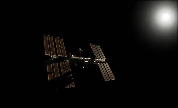 Uluslararası Uzay İstasyonu, Dünya 'nın atmosferine ve uzayına karşı siluetlendi. Arka planda güneş panelleri görünür ve parlak güneş ışığı vardı.. 