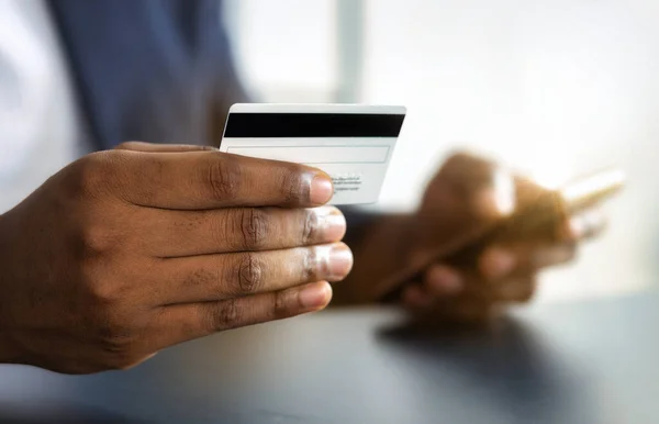 stock image Online banking, bill payment concept. Credit card in hand African American man close-up. Copy space