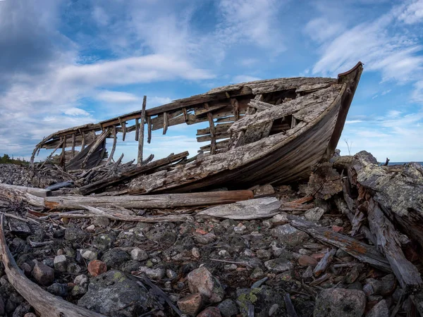 stock image Wreck of a wooden boat on a rocky shore