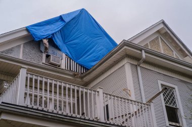 NEW ORLEANS, LA, ABD - 21 Kasım 2022: Bir ev yangınının ardından mavi bir muşamba ile korunan çatı 
