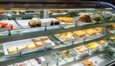 Assortment of pastries and sandwiches in a display case at a modern bakery shop in New Orleans, Louisiana, USA