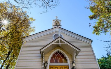 NEW ORLEANS, LA, USA - JANUARY 15, 2023: Front of historic St. Mary's Chapel with a sun star coming through the trees in the background