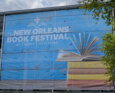 NEW ORLEANS, LA, USA - MARCH 14, 2024: The New Orleans Book Festival banner displayed outside the student center at Tulane University clipart