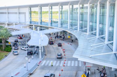 NEW ORLEANS, LA, ABD - 30 Nisan 2024: Louis Armstrong Uluslararası Havalimanı 'na varanlar için araç trafiği ve taksi hattının dış görüntüsü 