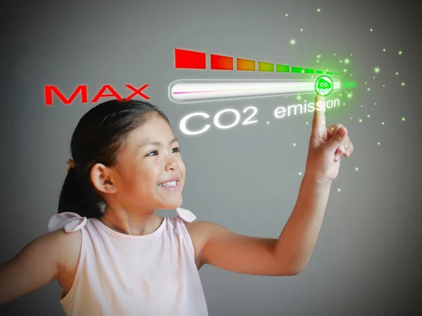 Carbon dioxide emissions control and reduction or removal to limit global warming and climate change. A girl adjusting the volume of CO2 emission on the progress bar to min.