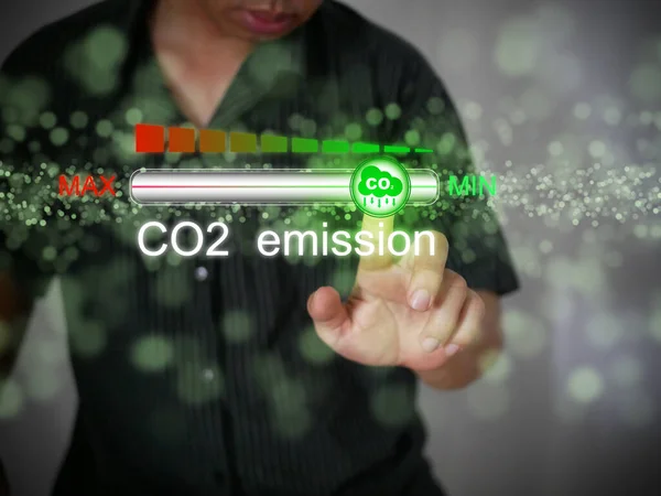 Carbon dioxide emissions control and reduction or removal to limit global warming and climate change. A man adjusting the volume of CO2 emission on the progress bar to min.