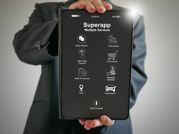 Hand of a businessman holds a tablet with superapp that serves multiple services as a one stop service