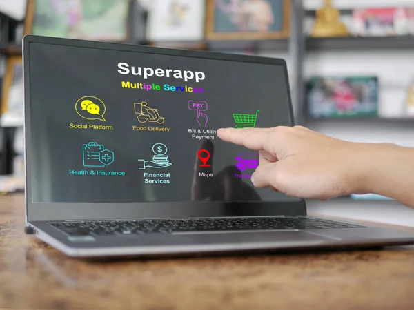 Finger about to tap on a screen of superapp on computer notebook or laptop that serves multiple services as a one stop service