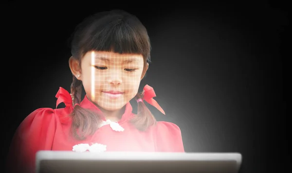 A girl scans her face using a tablet to unlock it. Facial recognition or detection. Biometric security system. Cybersecurity tech concept. Business, Science, and technology