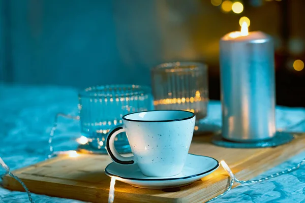 cup of tea and candles on the table