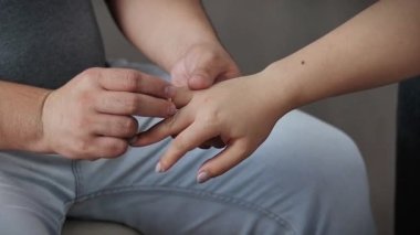 A man gives a gift to a girl a gold jewelry, a red box with a gold chain for a girl, valentine's day, valentine's day gifts