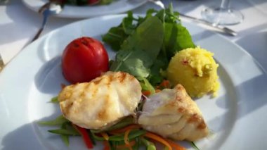 top view of a plate of fish fillet with mashed potatoes, restaurant table view with food