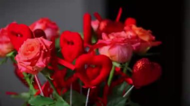 ed roses with red hearts, a bouquet of roses with hearts for Valentine's Day, a bouquet of roses for March 8